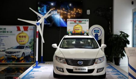 A Trumpchi GA5 hybrid electric car is displayed at an electric car dealership in Shanghai